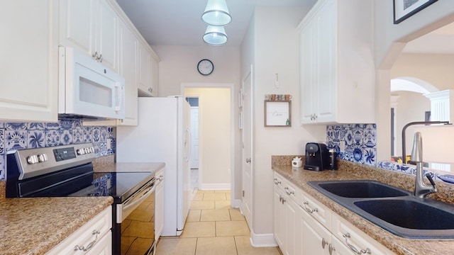 kitchen with light tile patterned flooring, sink, white cabinetry, tasteful backsplash, and electric stove