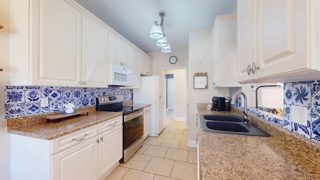 kitchen featuring white appliances, sink, decorative backsplash, and white cabinets