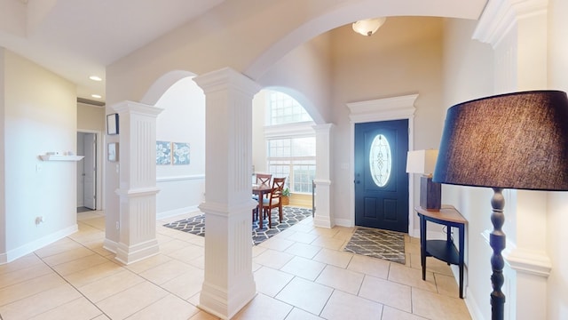 tiled entryway featuring decorative columns