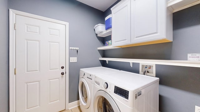 laundry area with cabinets and washing machine and clothes dryer