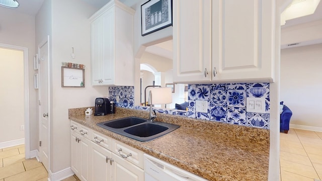 kitchen featuring sink, white cabinets, and light tile patterned flooring