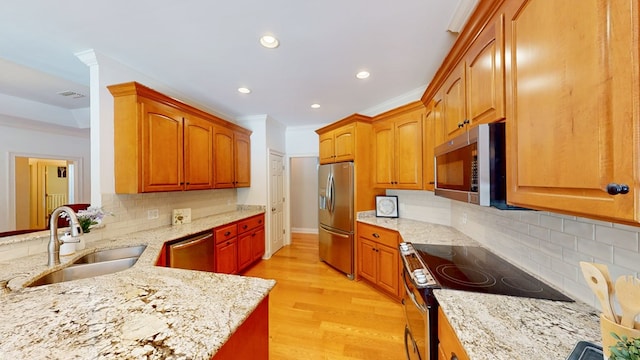 316 Bellingham Dr, Thomasville, GA 31792 - kitchen featuring stainless steel appliances, recessed lighting, light stone counters, light wood-style floors, and decorative backsplash