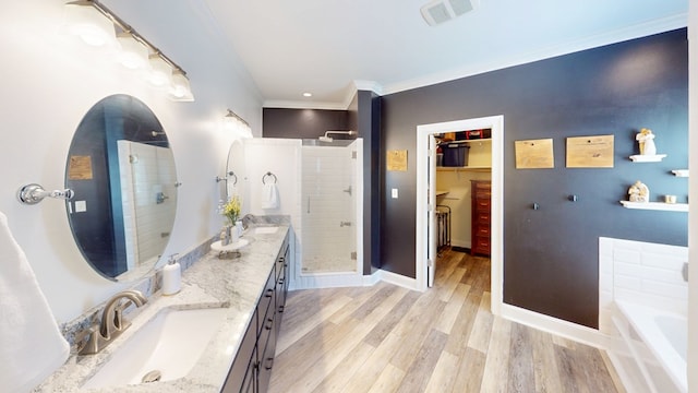 316 Bellingham Dr, Thomasville, GA 31792 - full bathroom with a stall shower, double vanity, ornamental molding, a garden tub, and wood finished floors