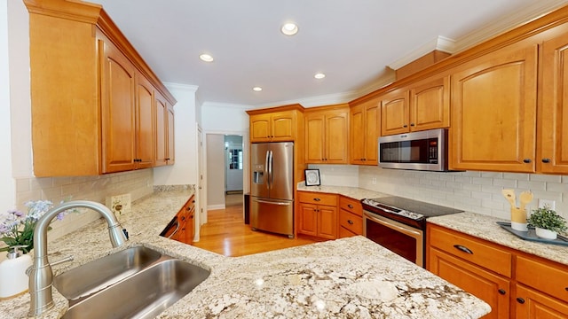 316 Bellingham Dr, Thomasville, GA 31792 - kitchen featuring stainless steel appliances, crown molding, light wood finished floors, light stone countertops, and decorative backsplash