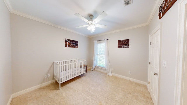 316 Bellingham Dr, Thomasville, GA 31792 - bedroom with light carpet, ornamental molding, a crib, and a ceiling fan