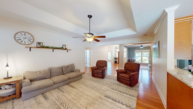 316 Bellingham Dr, Thomasville, GA 31792 - living area featuring ceiling fan, light wood finished floors, crown molding, ornate columns, and a raised ceiling