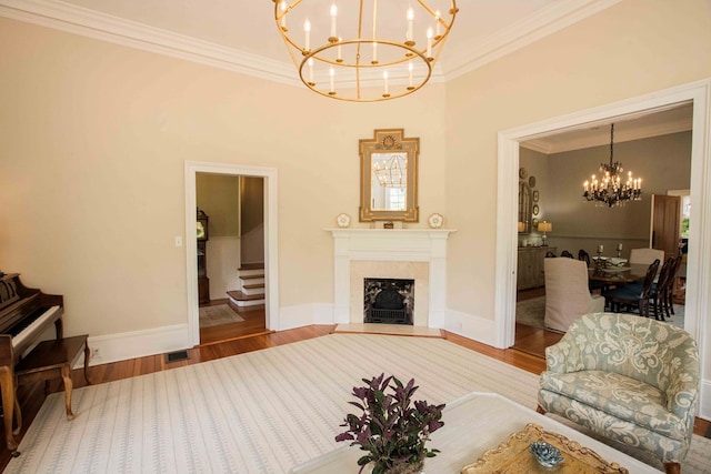 living room featuring ornamental molding, a chandelier, and hardwood / wood-style floors