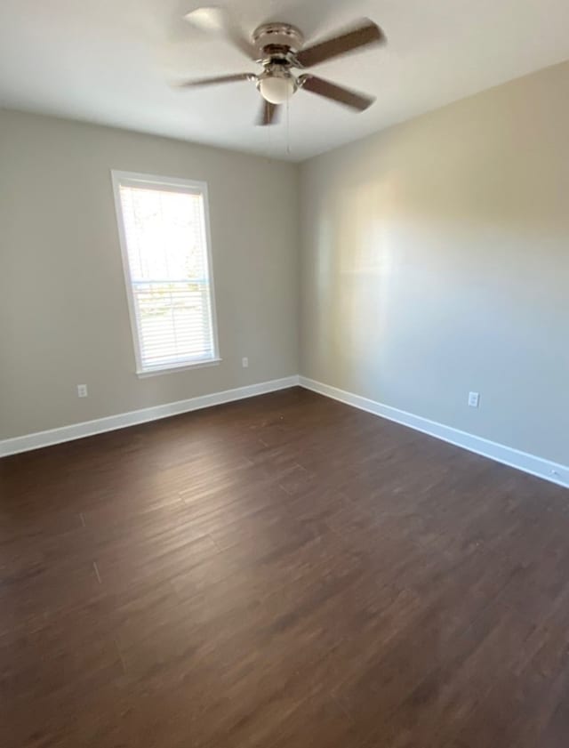 unfurnished room featuring ceiling fan and dark hardwood / wood-style flooring