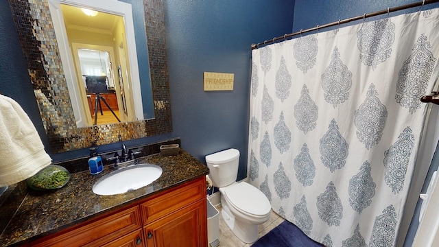 bathroom featuring crown molding, vanity, and toilet