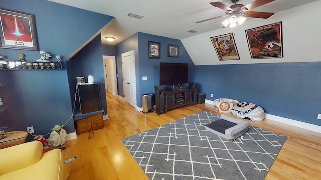 sitting room featuring hardwood / wood-style floors, vaulted ceiling, and ceiling fan