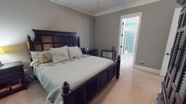 bedroom with ornamental molding and ensuite bathroom