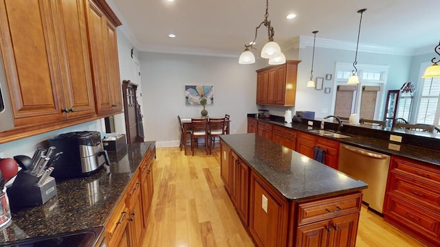 kitchen with pendant lighting, sink, dark stone countertops, a center island, and stainless steel dishwasher