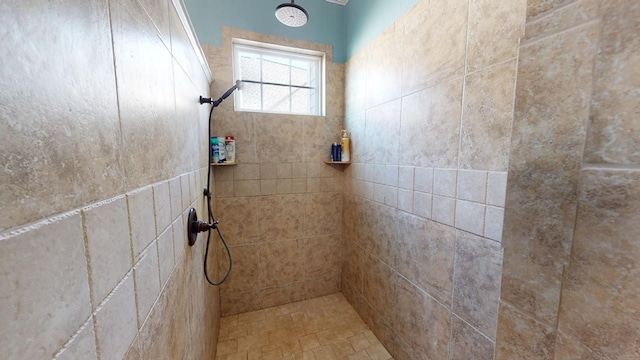 bathroom with a tile shower