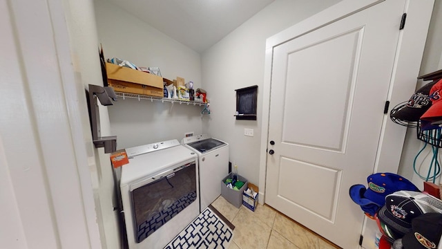 laundry room with separate washer and dryer and light tile patterned floors