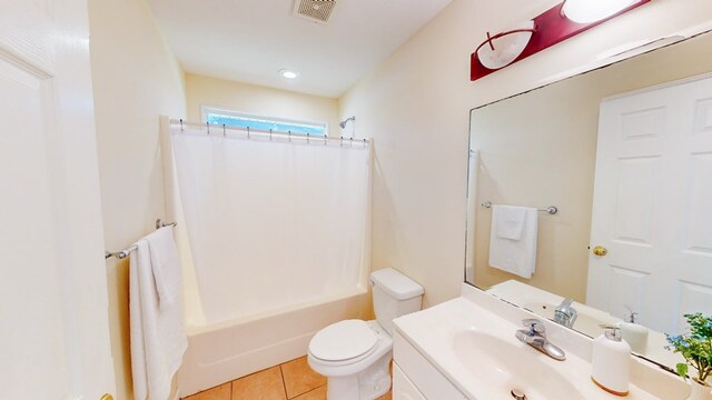 full bathroom with tile patterned floors, toilet, vanity, and shower / bath combo