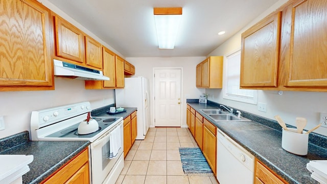 kitchen with sink, white appliances, and light tile patterned flooring