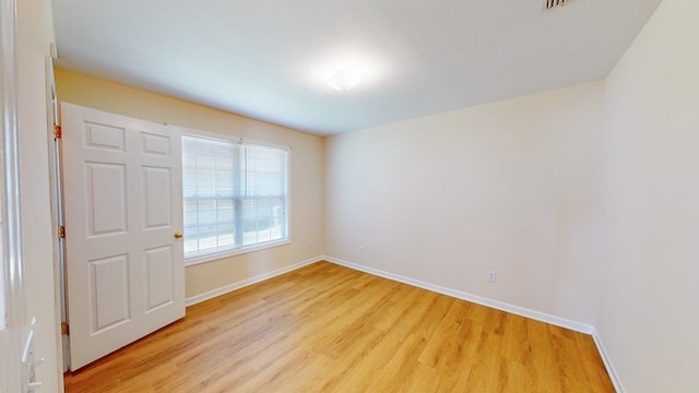 unfurnished room featuring light hardwood / wood-style floors