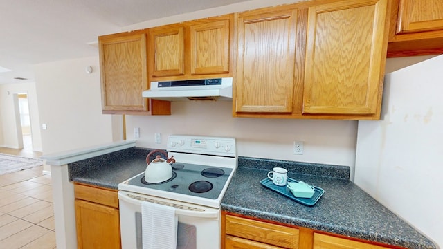 kitchen featuring light tile patterned floors and electric range