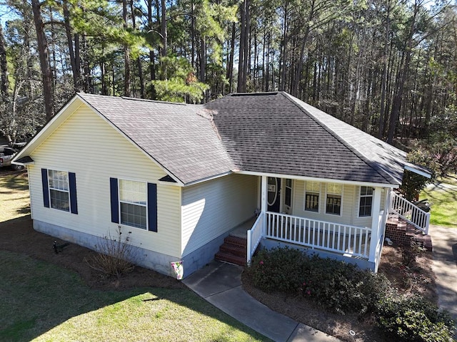 view of front of property featuring a porch and roof with shingles