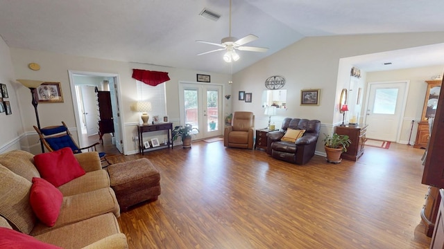 living room with ceiling fan, wood finished floors, visible vents, vaulted ceiling, and french doors