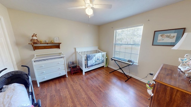 bedroom featuring a ceiling fan, baseboards, and wood finished floors