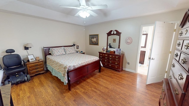 bedroom featuring light wood finished floors, baseboards, and a ceiling fan