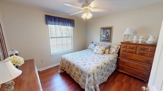 bedroom with dark wood-style flooring, ceiling fan, and baseboards