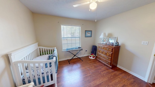 bedroom with ceiling fan, wood finished floors, and baseboards