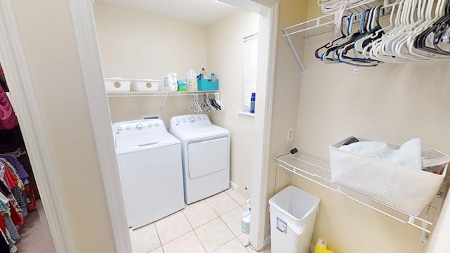 washroom featuring laundry area, washing machine and dryer, and tile patterned floors