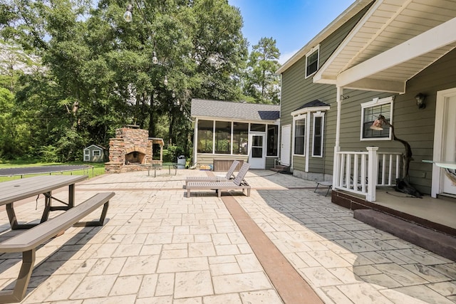 351 Plantation Ln, Thomasville, GA 31757 - view of patio / terrace featuring a sunroom and an outdoor stone fireplace