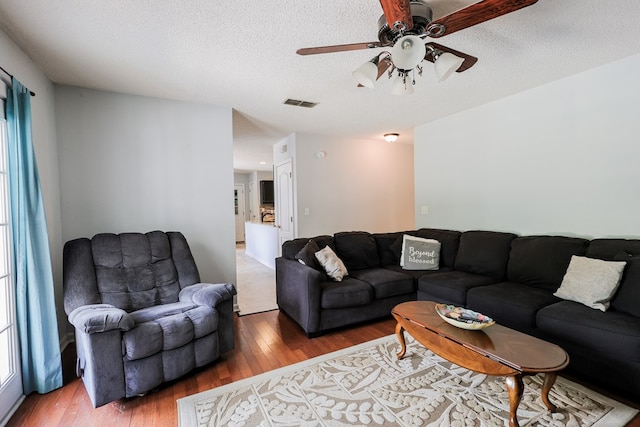 351 Plantation Ln, Thomasville, GA 31757 - living room with wood finished floors, a ceiling fan, and a textured ceiling