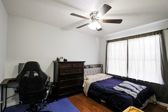 351 Plantation Ln, Thomasville, GA 31757 - bedroom with dark wood-style flooring, a desk, a textured ceiling, and ceiling fan