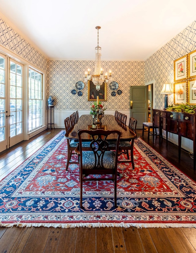 dining space featuring an inviting chandelier, wood-type flooring, and french doors