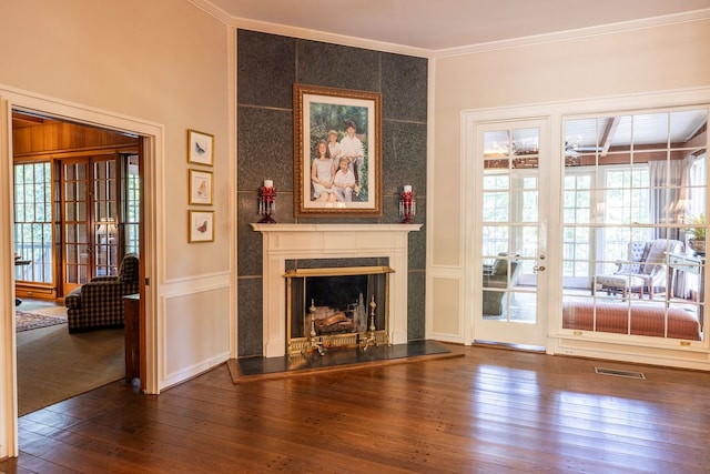 unfurnished living room with crown molding and wood-type flooring