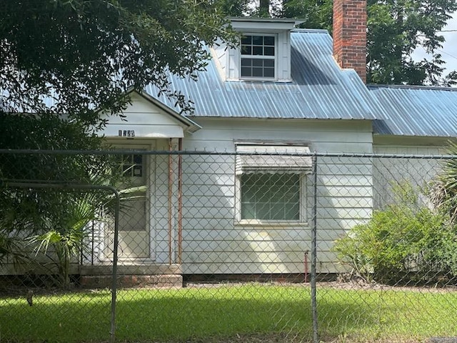 1225 N Stevens St, Thomasville, GA 31792 - view of side of property featuring a metal roof and a chimney