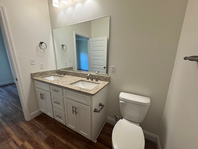 bathroom with vanity, hardwood / wood-style floors, and toilet