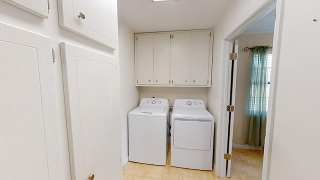 clothes washing area with cabinets and independent washer and dryer