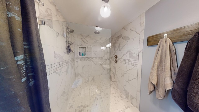 bathroom with tiled shower