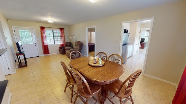 dining space featuring light tile patterned floors