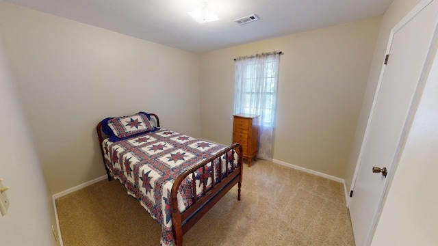 bedroom featuring light carpet