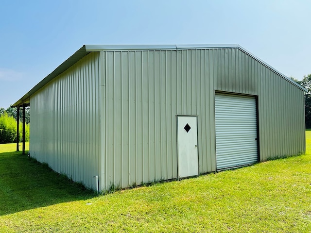 view of outbuilding with a garage and a yard