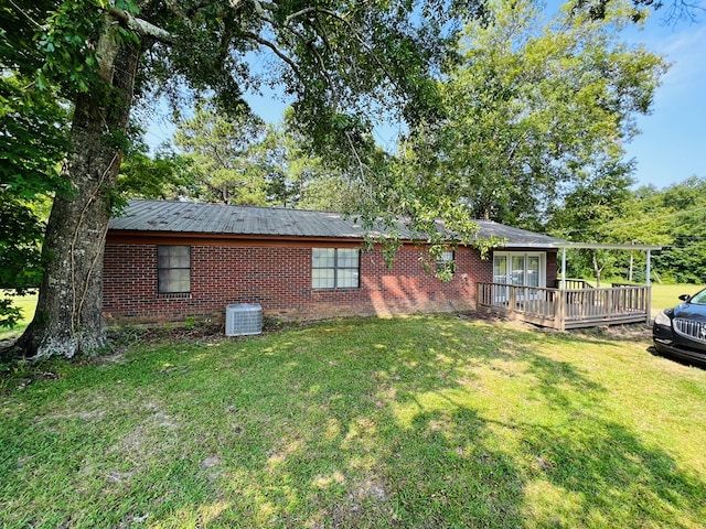 back of house featuring a deck and a lawn