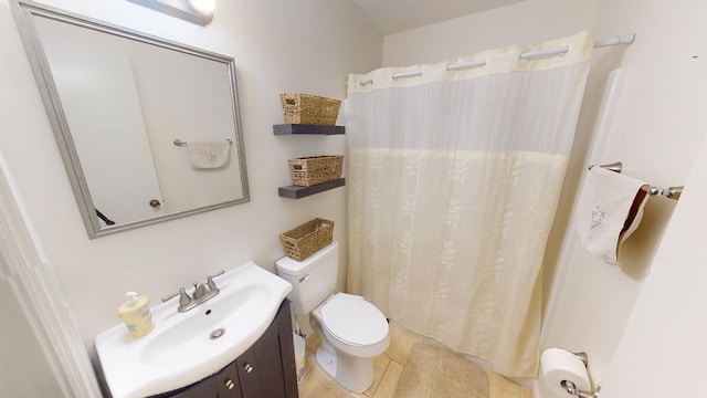 bathroom featuring vanity, tile patterned flooring, and toilet