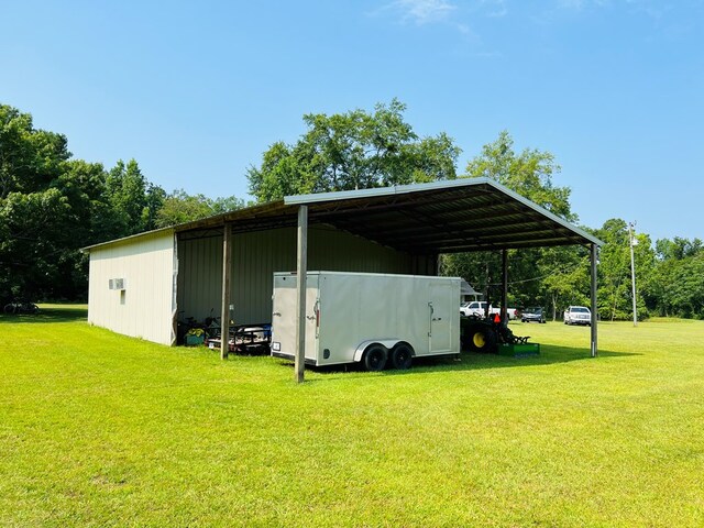 view of vehicle parking with a carport and a lawn