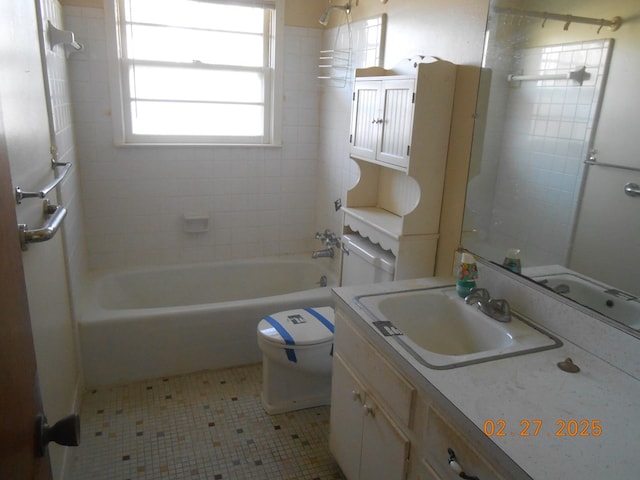 bathroom featuring toilet, shower / bath combination, and vanity