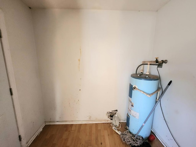 utility room featuring water heater