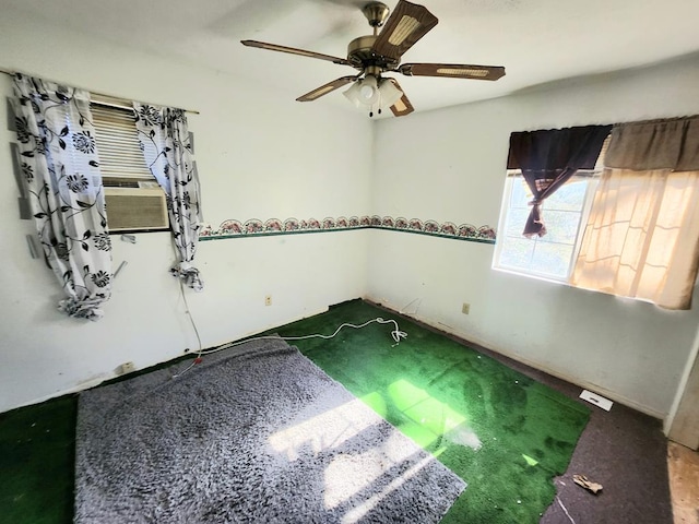 unfurnished room featuring cooling unit and ceiling fan