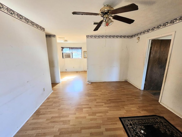 empty room featuring ceiling fan and light hardwood / wood-style floors