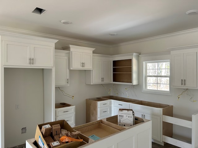 kitchen with white cabinets, crown molding, and open shelves