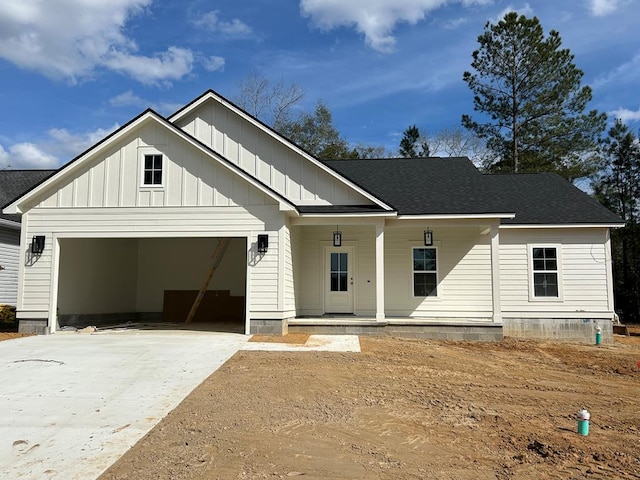 modern inspired farmhouse featuring a porch, an attached garage, a shingled roof, driveway, and board and batten siding